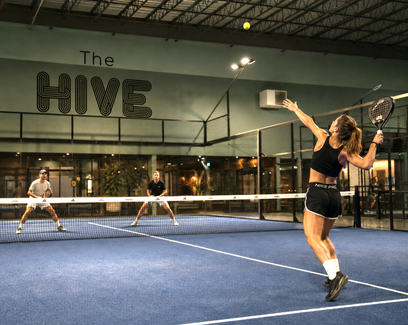 Players on an indoor padel court at The Hive